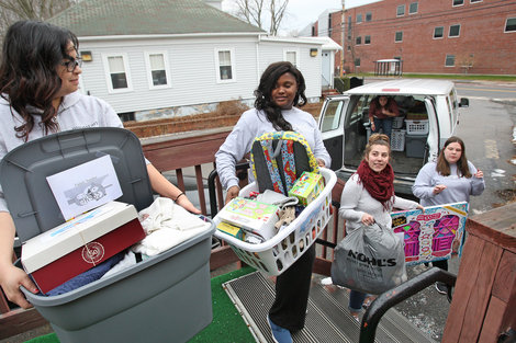 Jumpstart volunteers load toys for distribution Jumpstart volunteers load toys for distribution