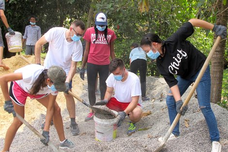 Student volunteers in Cambodia dig to install a filter Student volunteers in Cambodia dig to install a filter