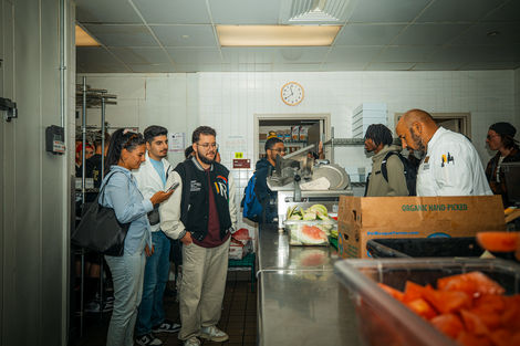 Students watch a man prepare food