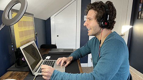 Dr. Kevin Duquette works on a computer in his home office.