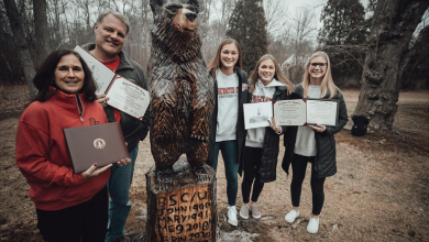 The McDonough family poses by their carved bear statue