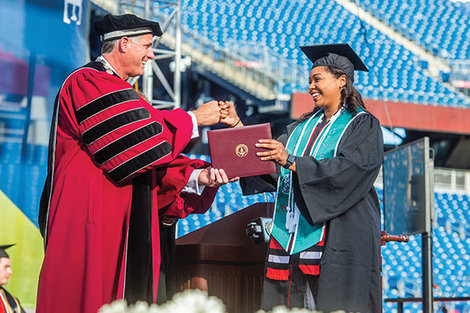 Fred Clark hands out a diploma