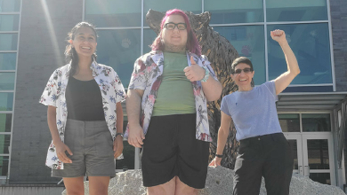 Cristina Dudziak, Elliot Philie and Lee Forest in front of bronze bear statue