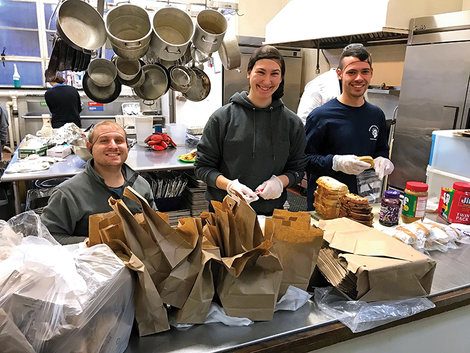 Marissa Morganelli, '19, along with fellow seniors Parker Smith (left) and Jason Silva, help prepare meals for the homeless in Washinton, D.C.,during a spring Alternative Break Trip.