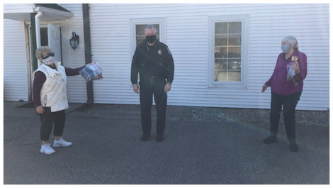 Gloria Moran, G'69 and Evie DeLutis, '63 deliver masks they made to local law enforcement