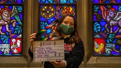 Molly Manning holds a director's clapboard