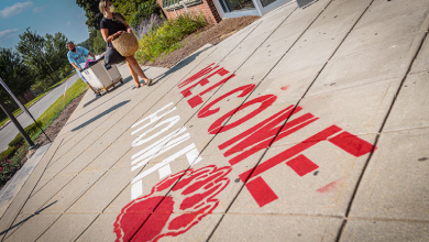 Students carry items as they move into residence halls
