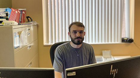 Connor O’Neal works at a computer.