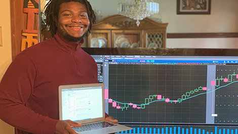 Petroy Thompson shows how he monitored stocks from home.
