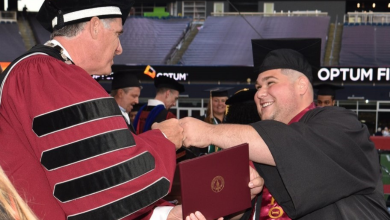 Benjamin Sangiolo receives his diploma from Fred Clark