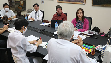 BSU and Japanese researchers sit at a conference table.