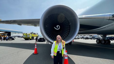 Sophia Schiappa stands in front of a large jet engine.