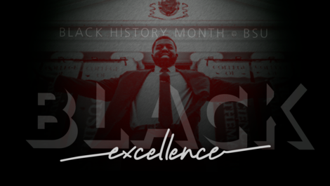 A man stands behind the words "excellence"