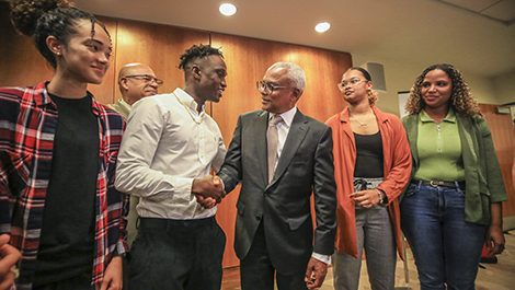 Cape Verde's president shakes hands with a BSU student as three other students look on.