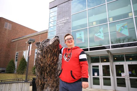 CJ standing next to the bear statue in front of the RSU