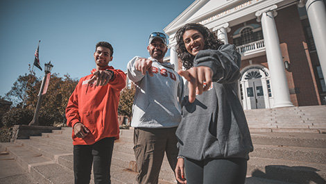 Tyler, Jim and Mya Lamonte pose for a photo in front of Boyden Hall.