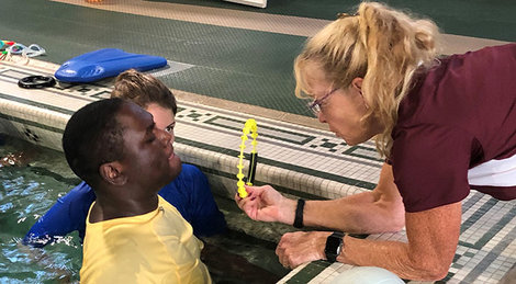 Susan Flynn, right, works with a participant in the FitCatZ program, which is based on BSU's Children's Physical Developmental Clinic.