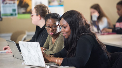 Two students work together at a desk