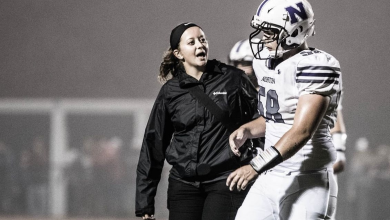 Kat Sevigny talks to a football player