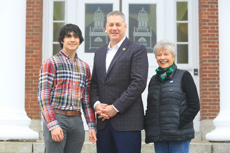 Peter Koutoujian, '25, Peter J. Koutoujian, '83 and Connie Koutoujian stand on steps of Boyden Hall