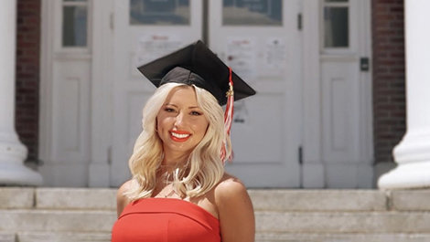 Kristina Picarski poses for a photo in her graduation cap in front of Boyden Hall.