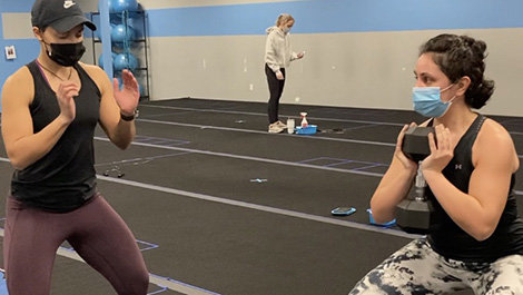 Lishanna Postell directs a client in a workout.