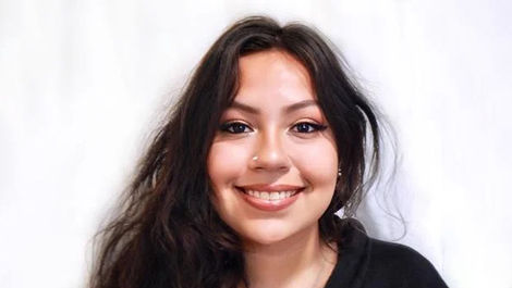 A headshot of Mitzy in front of a white background