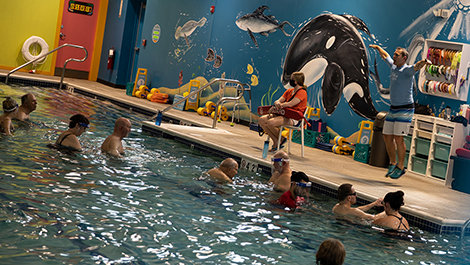 BSU students help Parkinson's patients exercise in a pool.