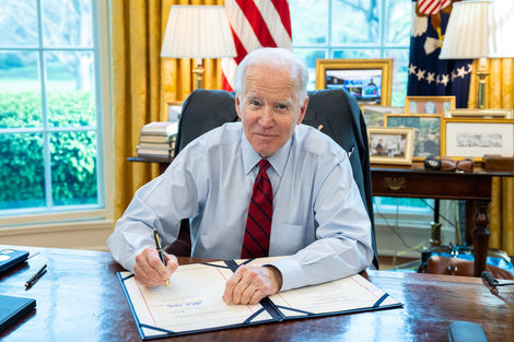 U.S. President Joe Biden singing a bill in the Oval Office