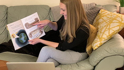 Stephanie Flood reads to students over the computer.