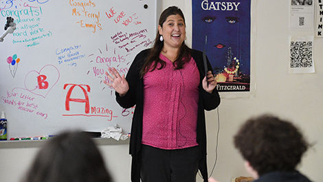 Shelley Terry teaches her class with congratulatory messages on the white board behind her.