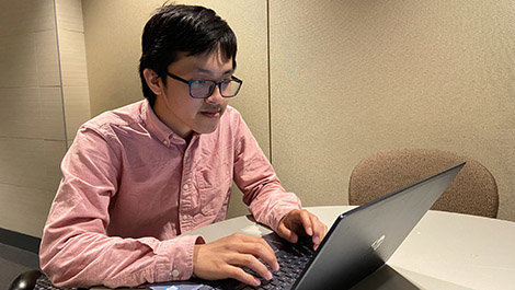 Lyhour Sreang works at a computer
