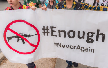 Sign saying "enough" with a "no guns" symbol Sign saying "enough" with a "no guns" symbol