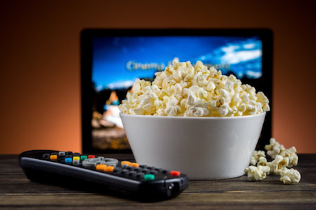 Stock photo of a bowl of popcorn with television in backgrou Stock photo of a bowl of popcorn with television in backgrou