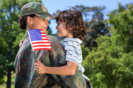 Veteran hugging child Veteran hugging child