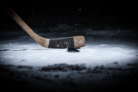 A hockey stick and puck A hockey stick and puck