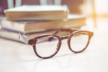 Eye glasses and school books Eye glasses and school books