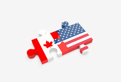 The U.S. and Canadian flags shown as jigsaw pieces fit toget The U.S. and Canadian flags shown as jigsaw pieces fit toget