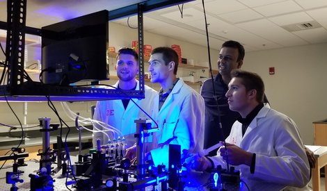 Brian Dolle, left, and Zachary Ells use the optical tweezers Brian Dolle, left, and Zachary Ells use the optical tweezers
