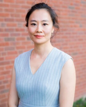 Dr. Alice Cheng smiling with her straight dark hair pulled back wearing a light blue sleeveless v-neck top