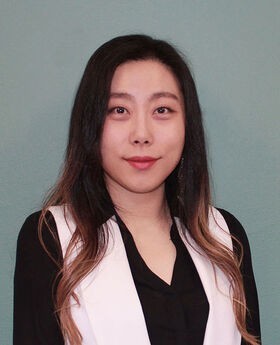 Dr. Hannarae Lee smiling with long straight dark hair and wearing a black and white blouse