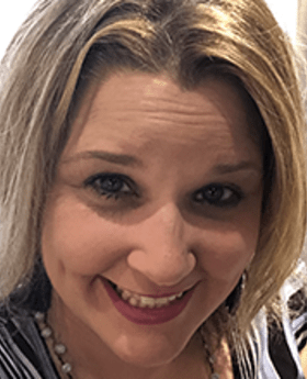 Close up headshot photo of Shannon Snyder smiling with shoulder length brownish blonde hair