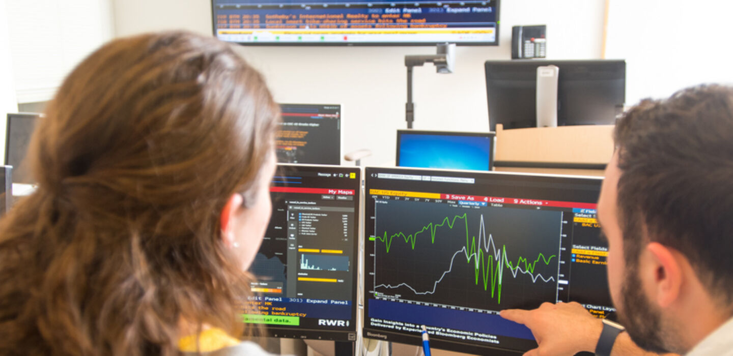 Management classroom with students using Bloomberg terminals