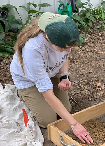 An archaeology student working at an on-site dig
