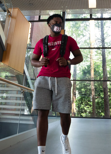 A masked student in the halls of BSU's science building