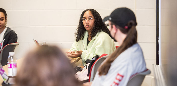 a student speaking in class while students around her listen